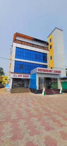 a large building with a yellow and blue building at Panda Continental in Bhubaneshwar