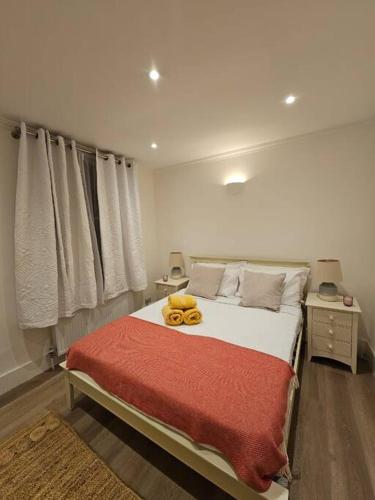 a bedroom with a bed with a teddy bear on it at Brook Green 2 bed flat in London