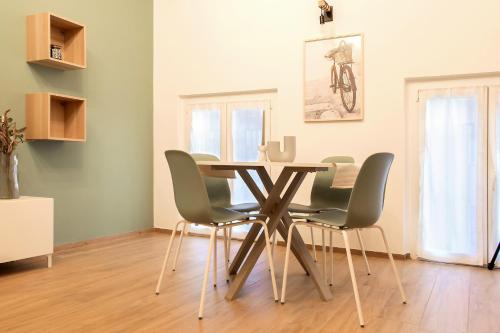 a dining room with a table and four chairs at Don Bi Apartments in Trecate