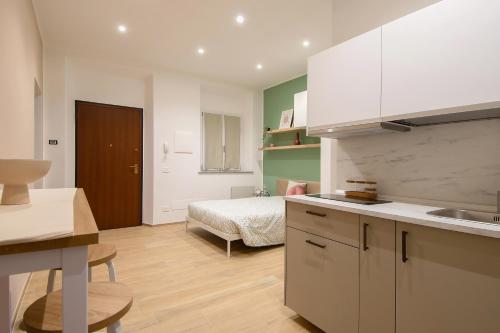 a kitchen with a sink and a bed in a room at Don Bi Apartments in Trecate