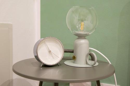 a lamp and a scale on a table at Don Bi Apartments in Trecate