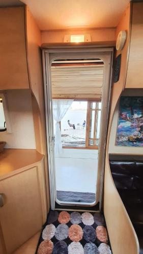 a small room with a window in an rv at Maliblues Bed & Art Gallery in Chumphon