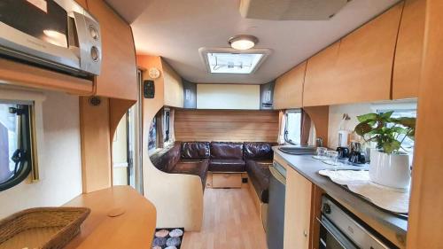 an interior view of a kitchen in an rv at Maliblues Bed & Art Gallery in Chumphon