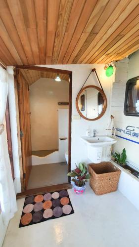 a bathroom with a toilet and a sink at Maliblues Bed & Art Gallery in Chumphon