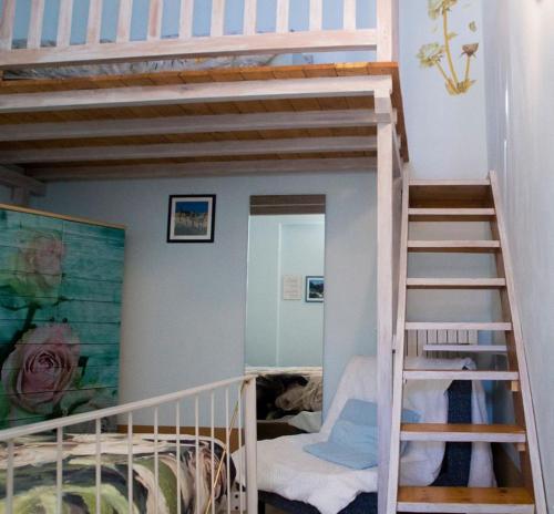 a small room with a bunk bed and a staircase at AGRITURISMO B&B BIO LA TANA DEL LELE in Serra San Quirico