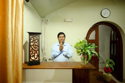 een man die voor een spiegel staat bij hotel ustav in Bolpur