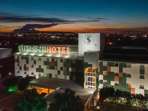 a building with a sign on it at night at Strassen Hotel in Goiânia