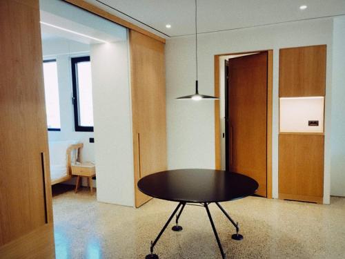 a dining room with a table and a hallway at Athens Tower Hotel by Palladian Hotels in Athens