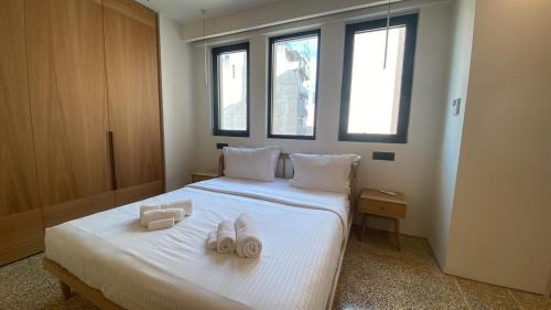 a bedroom with a bed with two towels on it at Athens Tower Hotel by Palladian Hotels in Athens