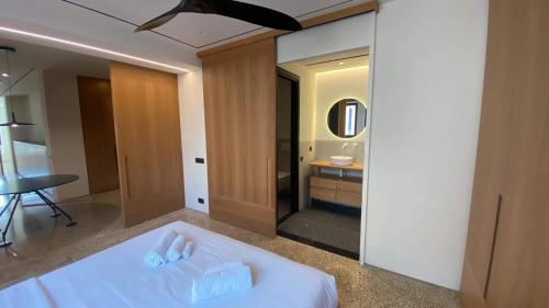 a bedroom with a white bed and a mirror at Athens Tower in Athens