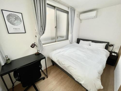 a bedroom with a bed and a desk and a window at BISK PARK Higashi-Jujo in Tokyo