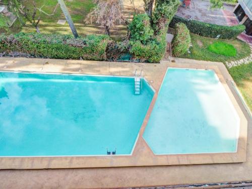 an overhead view of an empty swimming pool at Vinyet Tranquility by Hello Homes Sitges in Sitges