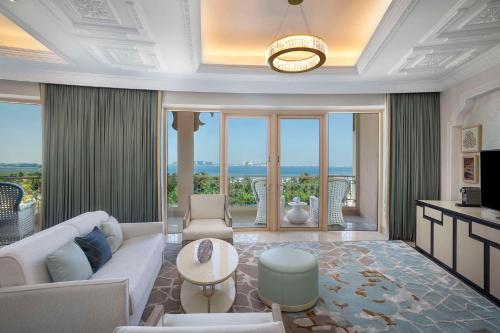a living room with a couch and a table at Waldorf Astoria Ras Al Khaimah in Ras al Khaimah