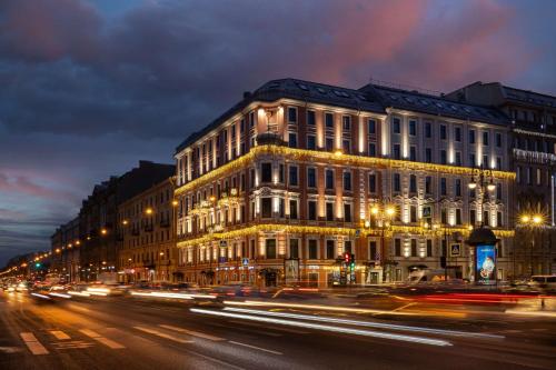 a building on a city street at night at Radisson Sonya Hotel in Saint Petersburg