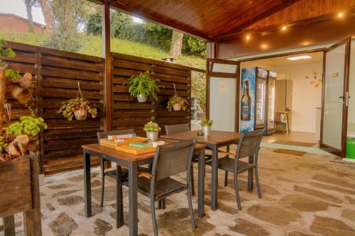 a dining room with a table and chairs at Cabana Sobreiro in Castelo de Paiva