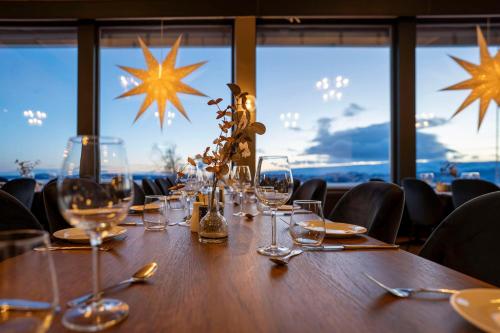 a wooden table with glasses and utensils on it at Radisson Blu Resort, Beitostølen in Beitostøl