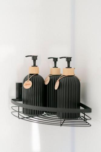 three black bottles on a shelf with spatulas at Whisky @ On The Rocks in Rock Valley