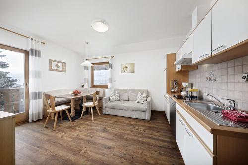 a kitchen with a table and a dining room at Langeshof Fewo Abendrot in Caines