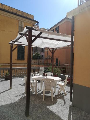 a table and chairs under an umbrella on a patio at Le Stanze del Notaio in Genova