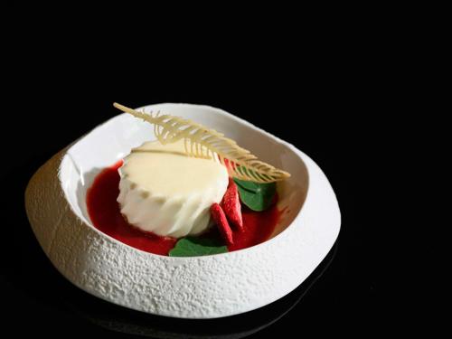 a dessert in a white bowl with strawberries and cream at ibis Budapest Stadium in Budapest