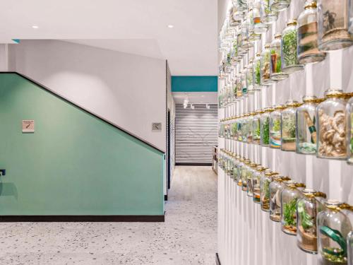 a store aisle with shelves filled with glass jars at ibis Styles Paignton in Paignton