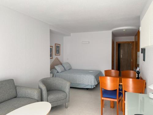 a living room with a bed and a table and chairs at La Colina in Albir