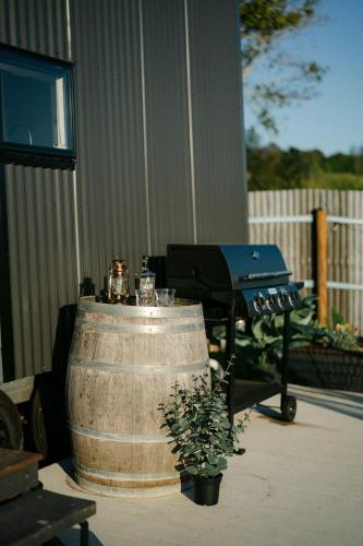 a grill and a b smoker in a yard at Whisky @ On The Rocks in Rock Valley