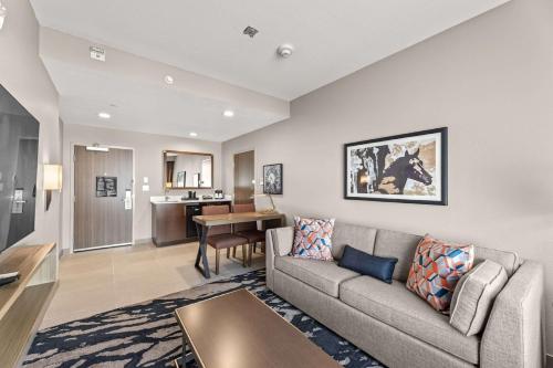 a living room with a couch and a table at Embassy Suites By Hilton Irving Las Colinas in Irving