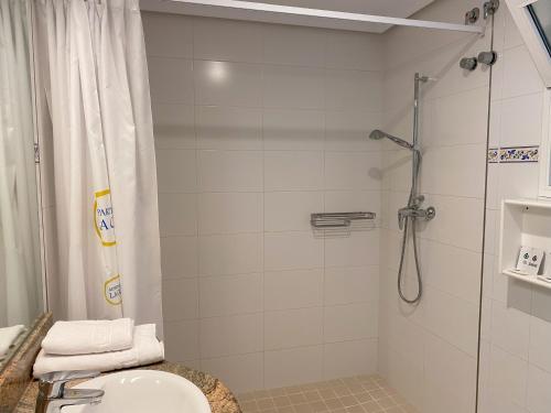 a bathroom with a shower with a sink and a toilet at La Colina in Albir