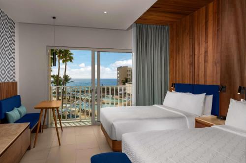a hotel room with two beds and a view of the ocean at Hilton Cancun Mar Caribe All-Inclusive Resort in Cancún