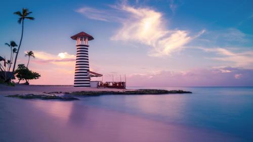 a lighthouse on a small island in the ocean at Hotel Olimpo in La Romana