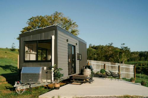 a tiny house with a patio and a fence at Whisky @ On The Rocks in Rock Valley