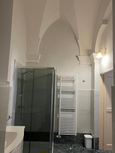 a bathroom with a shower and a glass shower stall at Palazzo Prence in Copertino