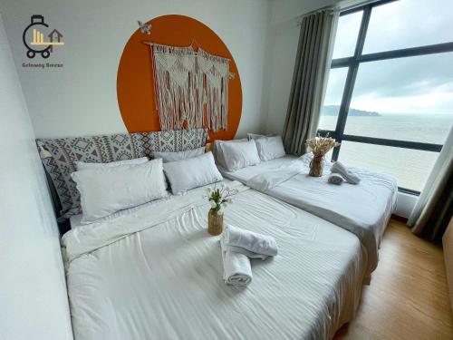 a hotel room with two beds with towels on them at 1 min to Seaview & Sunrise Heart of Kuantan in Kuantan