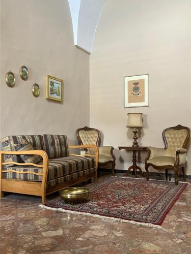 a living room with a couch and two chairs at Palazzo Prence in Copertino