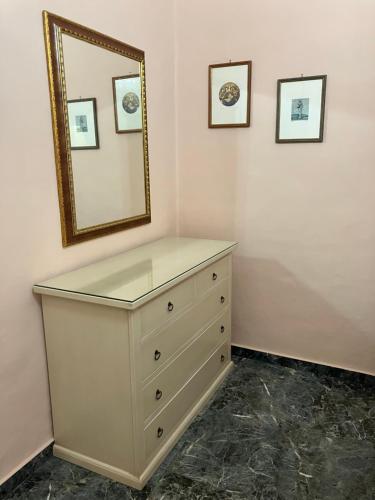 a dresser in a room with a mirror on the wall at Palazzo Prence in Copertino