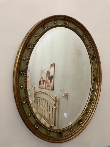 a mirror on a wall with a picture in it at Palazzo Prence in Copertino