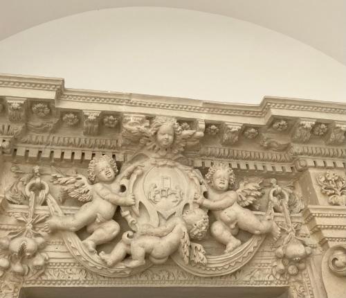 a stone building with statues on the side of it at Palazzo Prence in Copertino