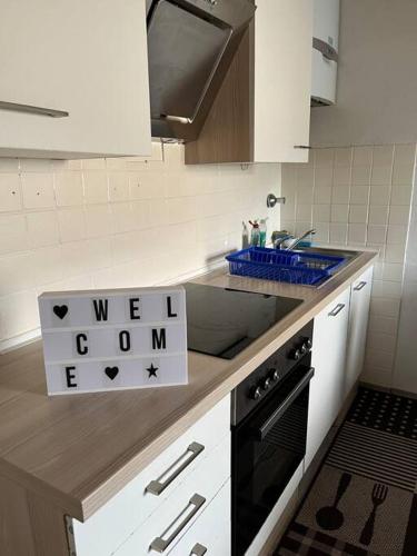 a kitchen with a sink and a sign on the counter at Wohlfühloase Leoben in Leitendorf