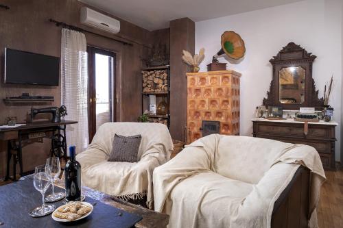 a living room with two chairs and a table at Luxury Apartment Flora, Stari Grad, Hvar Island in Stari Grad