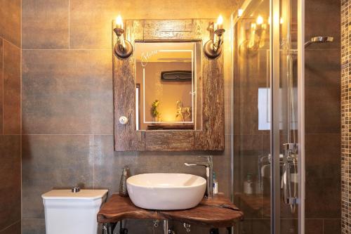 a bathroom with a sink and a toilet and a mirror at Luxury Apartment Flora, Stari Grad, Hvar Island in Stari Grad