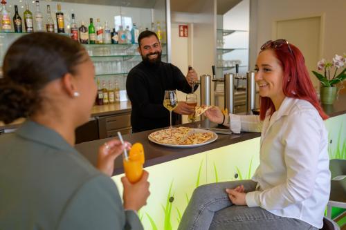 a group of people sitting at a bar eating food at ibis Heilbronn City in Heilbronn