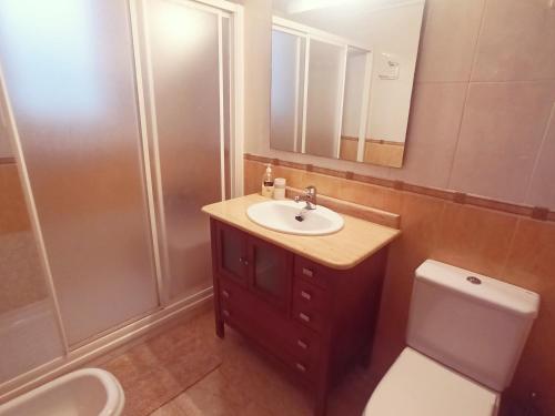 a bathroom with a sink and a toilet and a shower at Playa de Levante, Céntrico, AC, Wifi y Parking - by Aloha Palma in Águilas