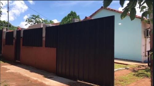 a black fence in front of a house at Grecovich House in Encarnación
