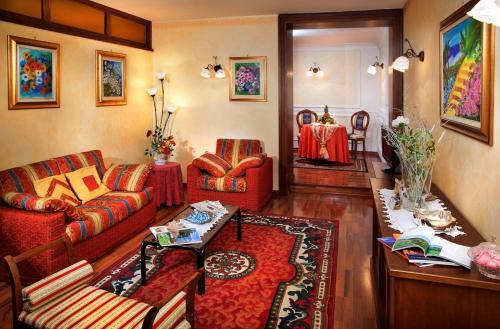 a living room with a couch and a table at Hotel La Ruota in Pianfei