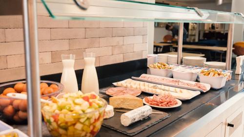 a buffet with different types of food on a counter at Holiday Inn Express Lille Centre by IHG in Lille