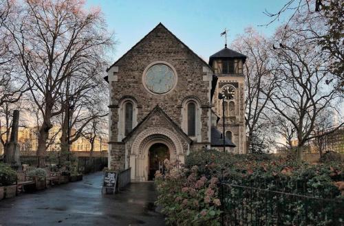 a church with a clock on the front of it at London Single Rooms Female only Kings Cross Eurostar St Pancras International Station Camden Euston all nearby check in from 1230 PM till 3AM in London