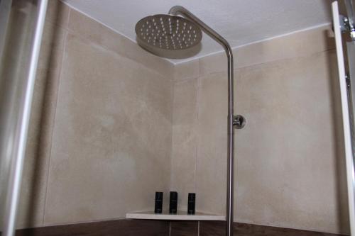 a shower in a bathroom with a shower head at Elounda Square Home in Elounda