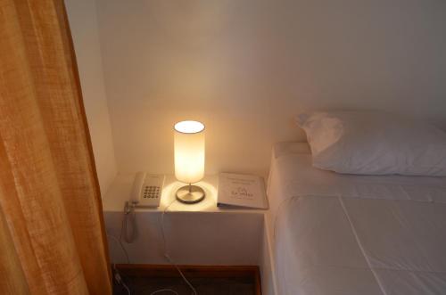 Una cama o camas en una habitación de Hotel La Aldea