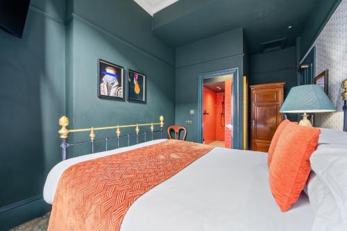 a bedroom with a large bed and blue walls at Clementine's Guest House in York